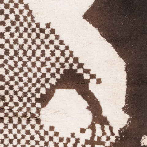 Detail view of a geometric pattern on a black and white tribal rug.