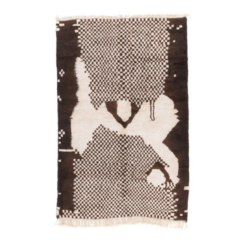 Front view of a tribal area rug showcasing black and white colors and fringed edges.