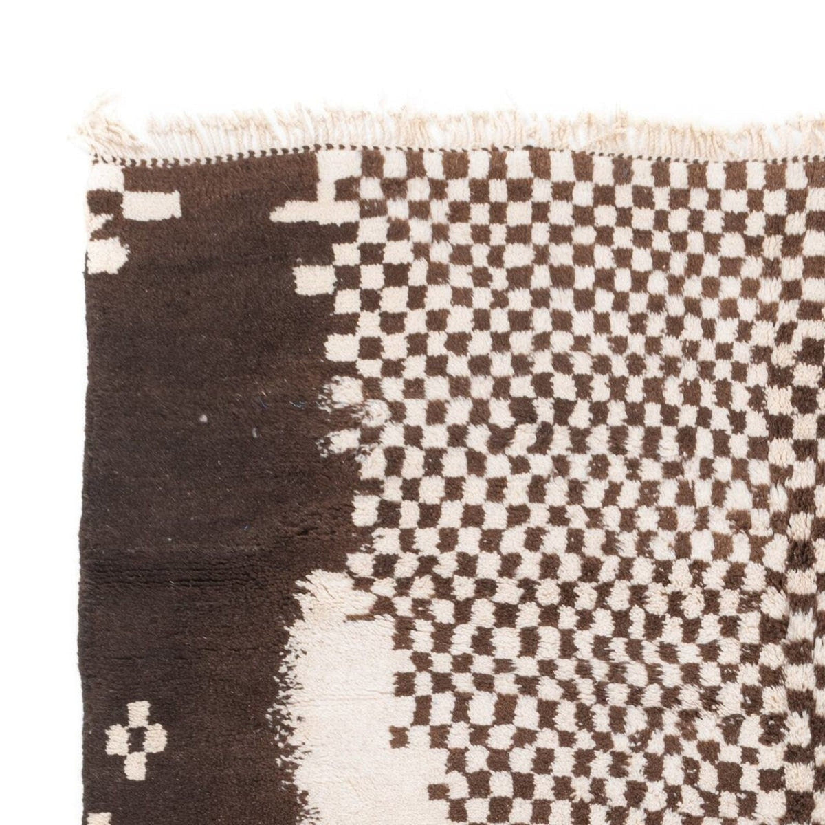 Close-up of a geometric design on a black and white tribal rug.