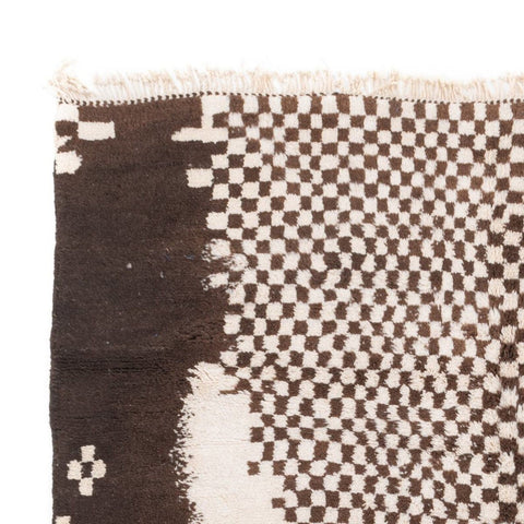 Close-up of a geometric design on a black and white tribal rug.