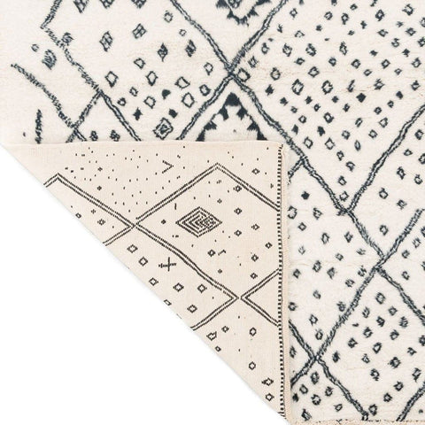 Close-up detail of the ivory geometric tribal area rug showcasing its geometric design.