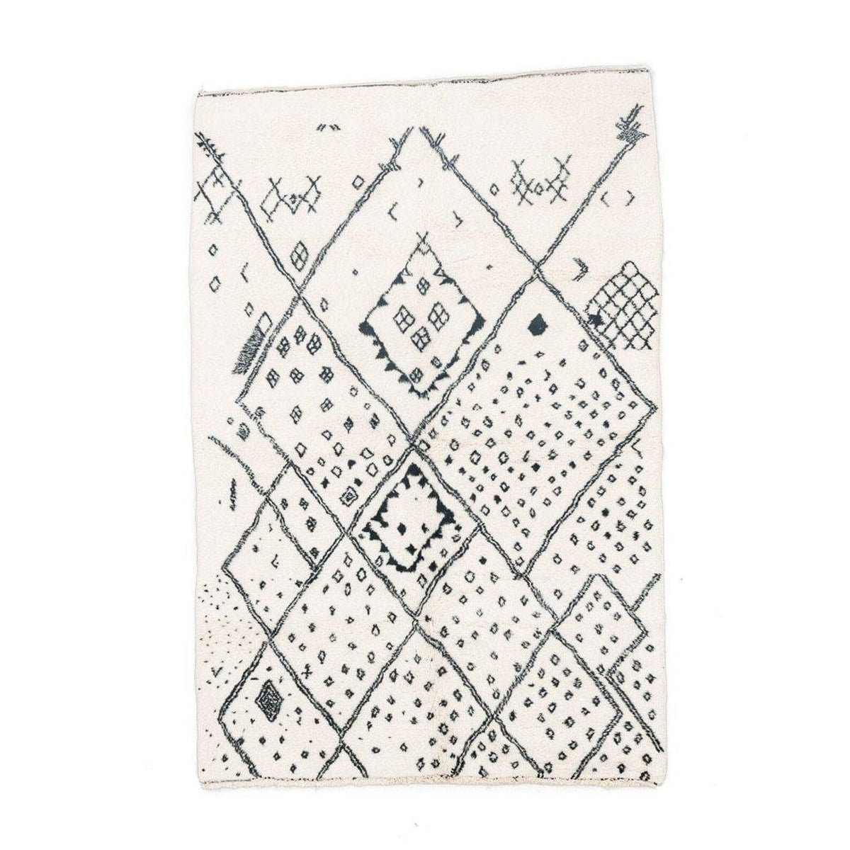 Front view of the ivory geometric tribal area rug featuring a black pattern.