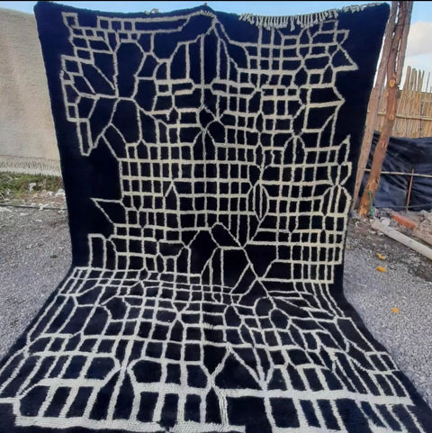 Front view of a black Moroccan Berber rug featuring geometric patterns.
