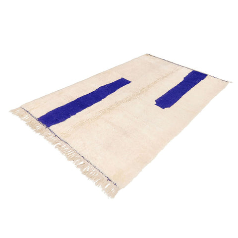 Side view of the blue and off-white Moroccan rug with a contemporary design.
