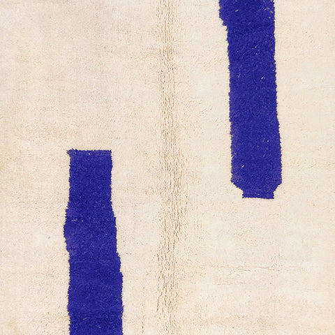 Close-up detail of the blue and off-white Moroccan rug featuring a contemporary design.