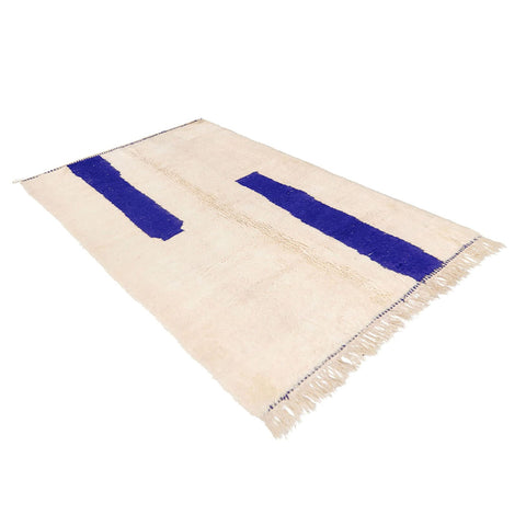 Close-up detail of the blue and off-white Moroccan rug showcasing its contemporary design.