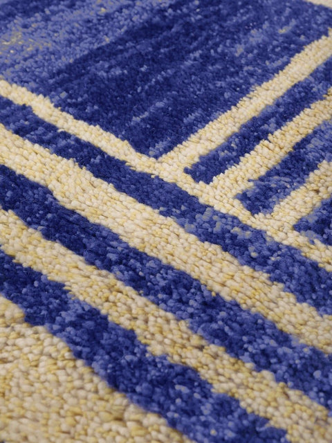 Close-up detail of the blue Beni Mrirt rug showcasing its striped design and soft texture.