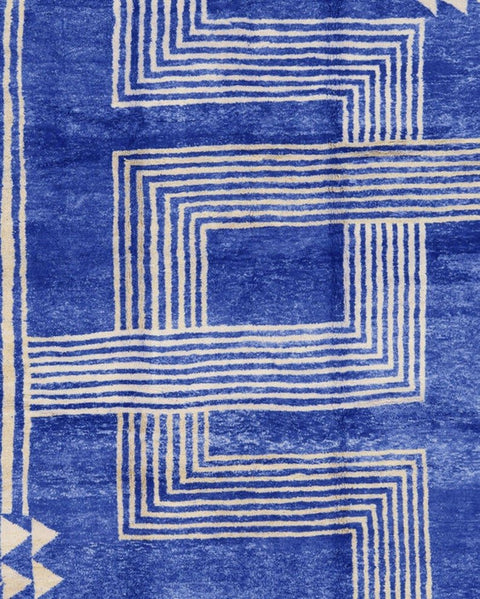 Close-up detail of the blue Beni Mrirt rug featuring geometric patterns against a cream backdrop.