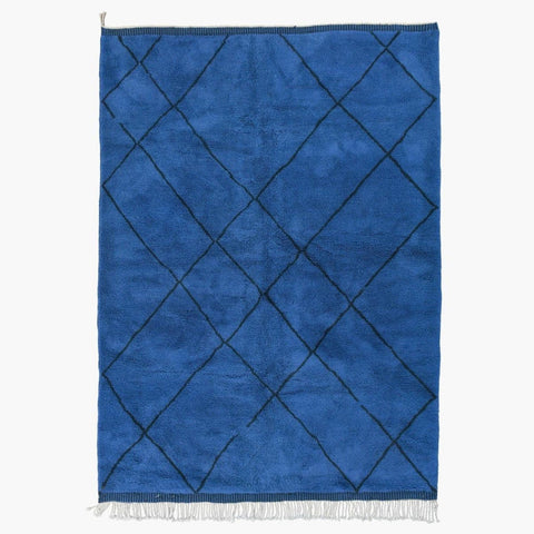 Front view of the blue diamond pattern rug with a white background.