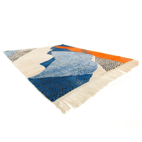 Close-up detail of the textured surface of the blue and cream abstract Moroccan rug.