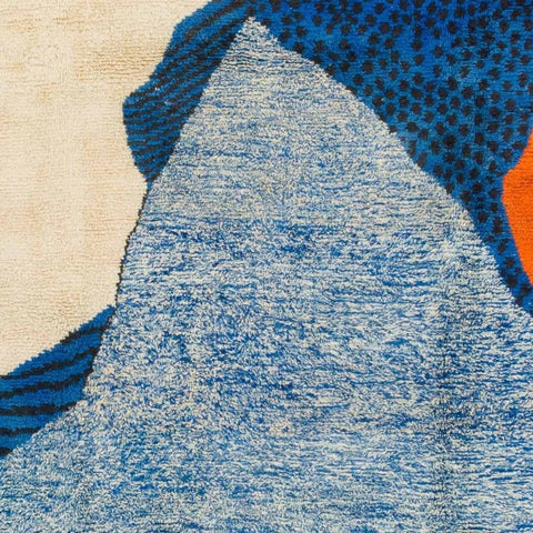 Front view of the blue, cream, and orange abstract Moroccan rug showcasing its geometric design.