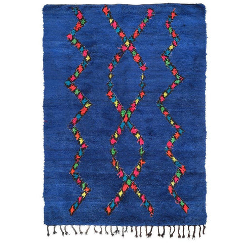 Front view of a blue Moroccan rug featuring an abstract Berber design with fringed edges.