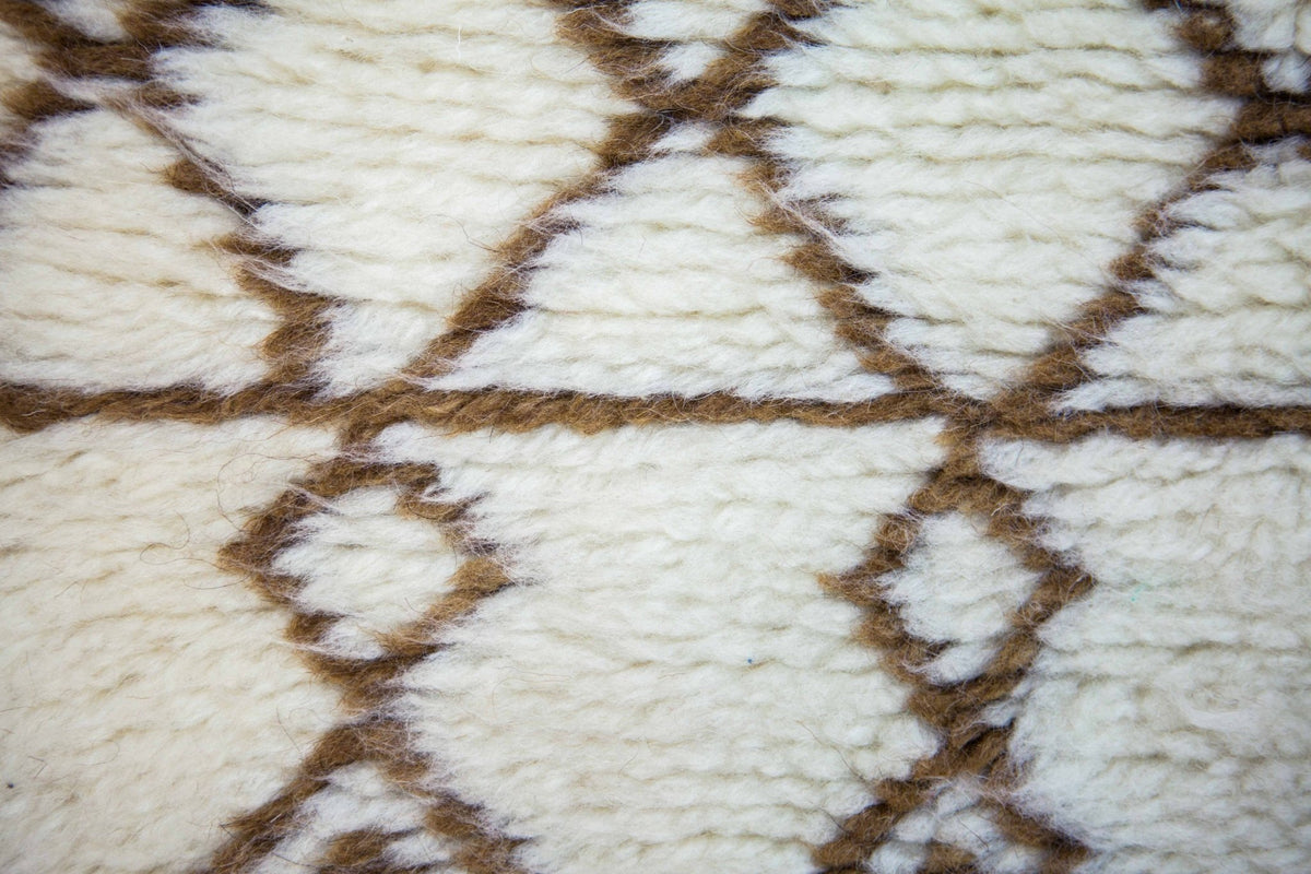 Front view of the brown striped Moroccan rug showcasing soft texture and tribal designs in black and off-white.