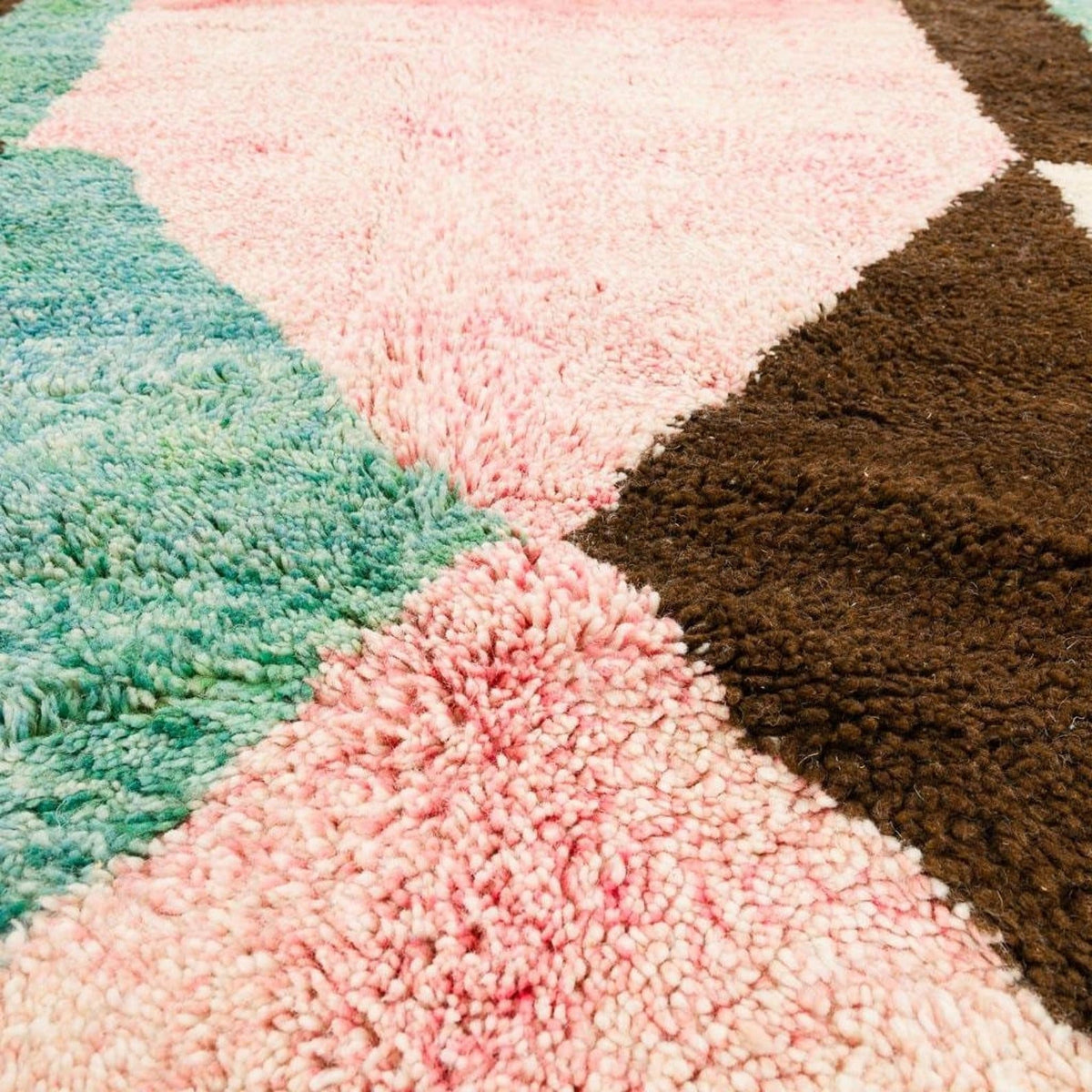 Front view of a colorful Moroccan rug showcasing a patchwork design with soft texture in various colors.
