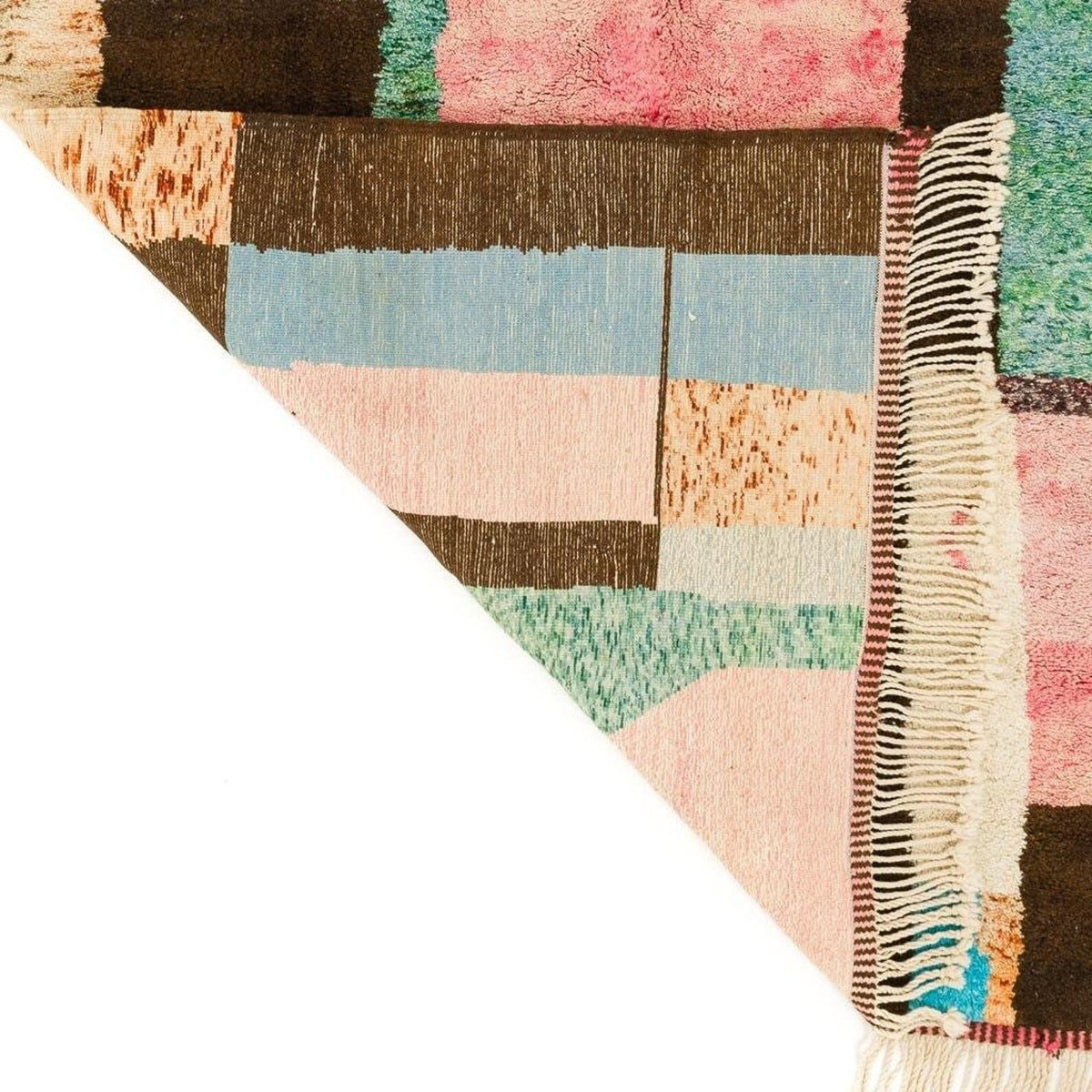 Close-up detail of the rug texture highlighting soft fibers and color variation in pink, brown, blue, and green.