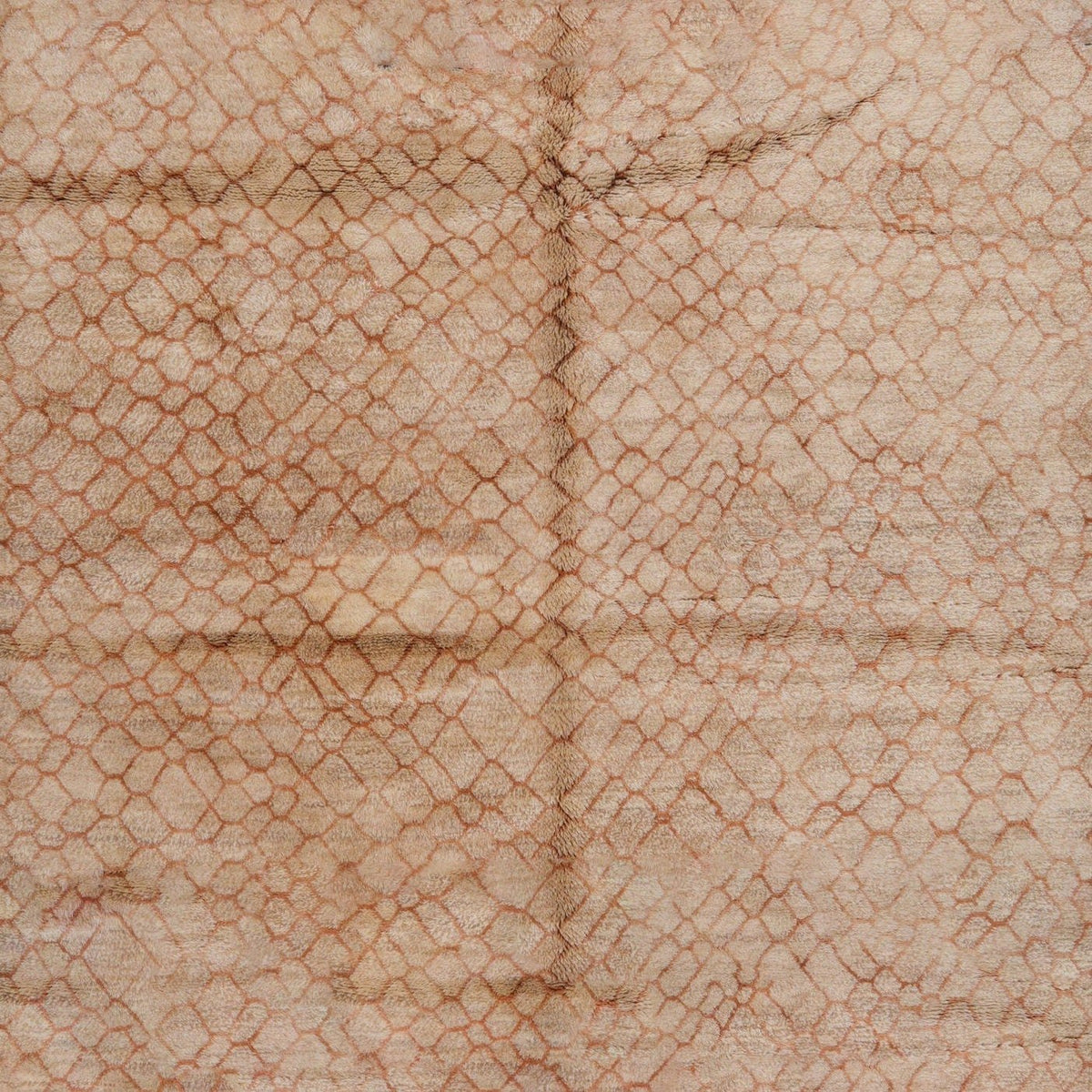 Close-up detail of the textured surface and abstract pattern of the brown Moroccan rug.