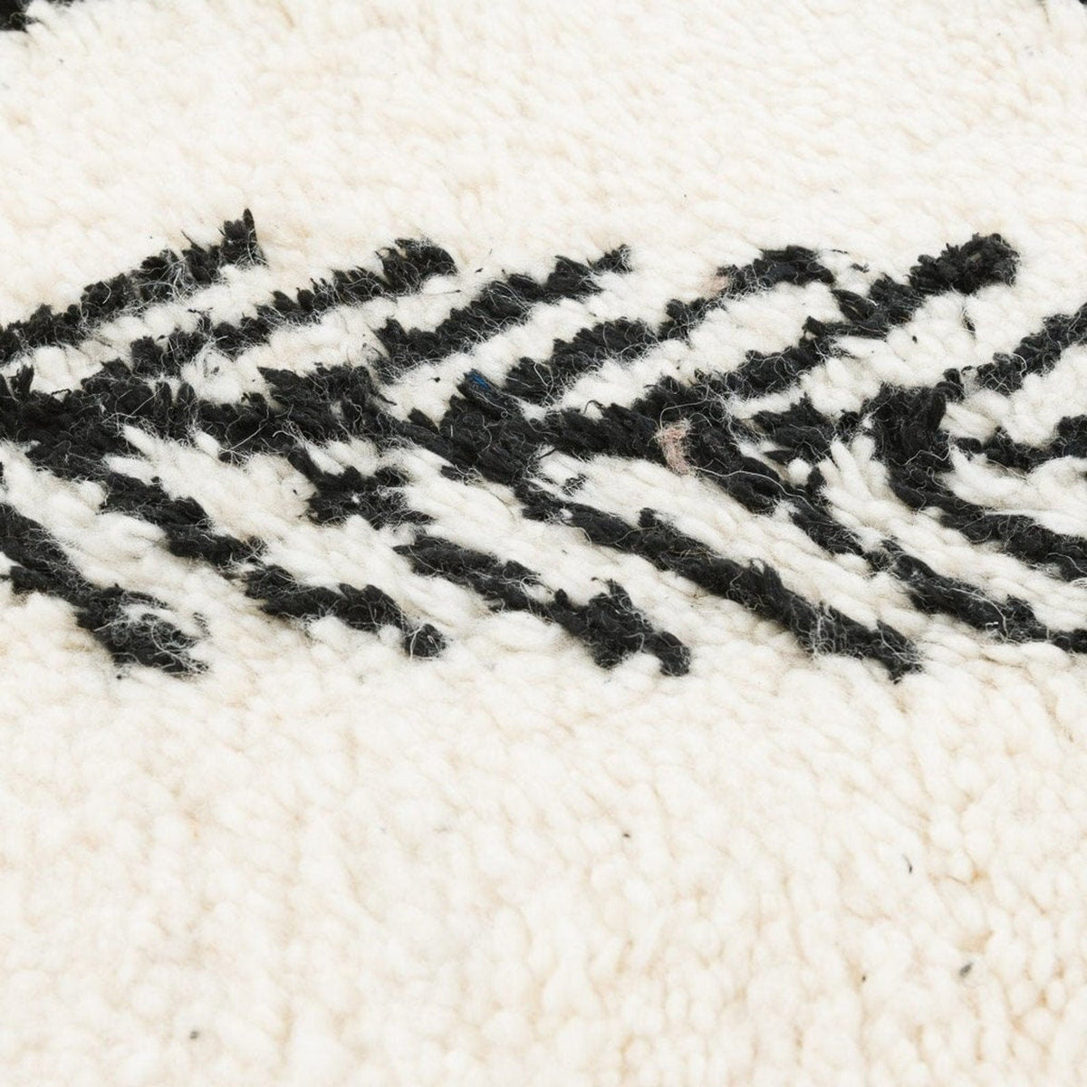 Close-up detail of the Moroccan rug displaying its textured pattern and handmade quality.
