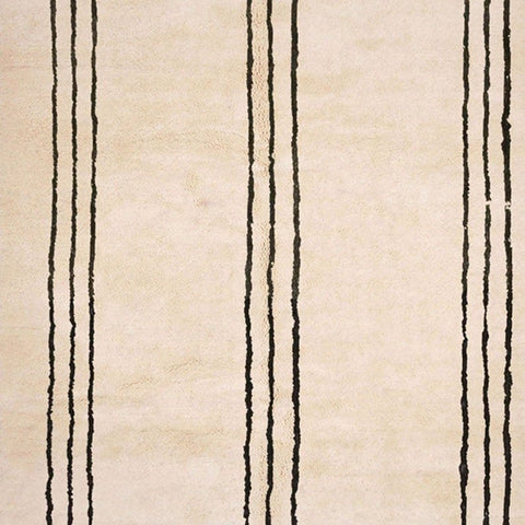 Side view of the beige striped Moroccan rug showing fringe edges on a white background.