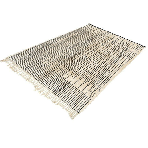 Front view of a contemporary Moroccan rug with fringe edges, highlighting its geometric design in black and white.