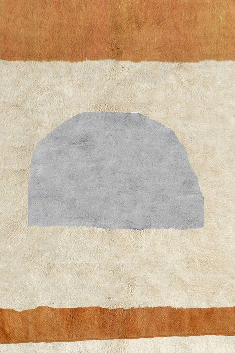 Side view of the Moroccan rug highlighting its geometric design in cream, orange, and gray.