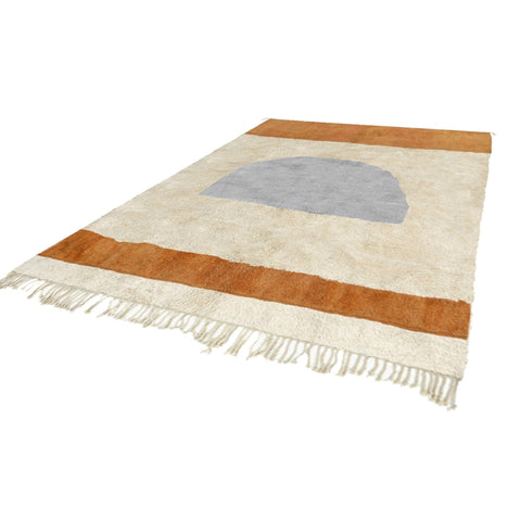 View of the contemporary Moroccan rug featuring fringe edges and an abstract design in cream, gray, and brown.