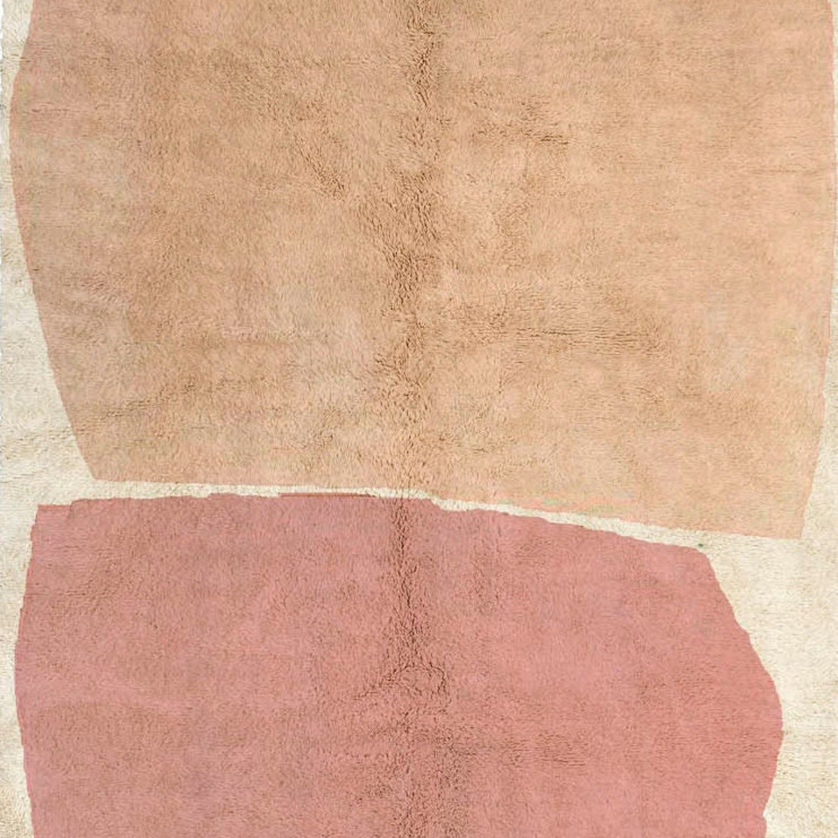 Detail close-up of the peach and coral color block Moroccan rug highlighting the pink and beige design.