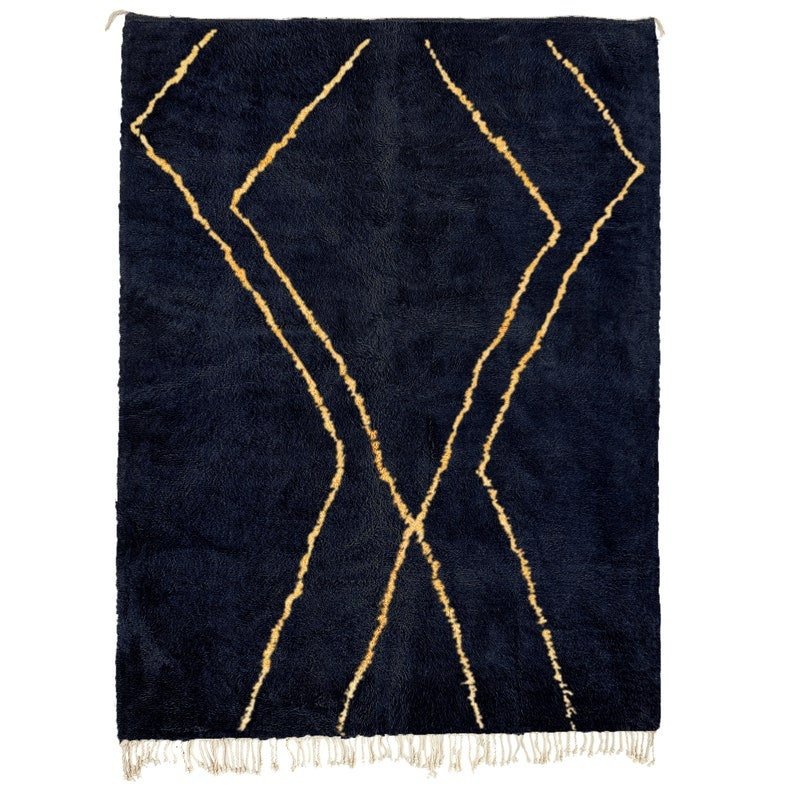 Detail close-up of a dark blue geometric design on a Moroccan rug.