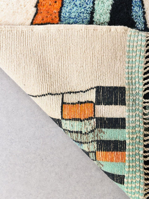 Front view of the abstract area rug showcasing geometric patterns in beige, blue, and orange.