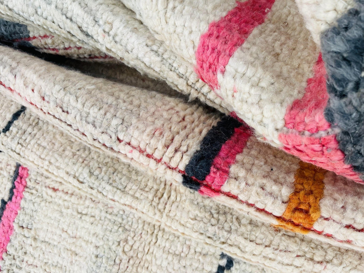 Lifestyle image showcasing the colorful patterns of a pink and red Moroccan rug.