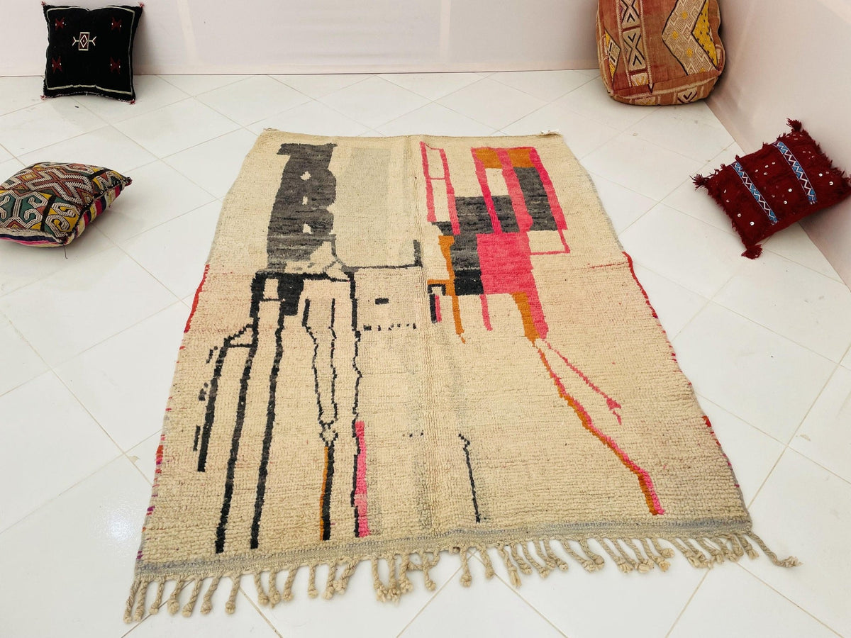 Lifestyle view of a vintage Moroccan rug featuring pink and red colors.