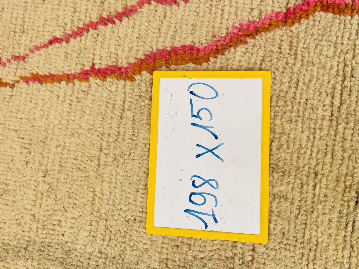 Detail view of bold lines and colors on a pink vintage Moroccan rug.