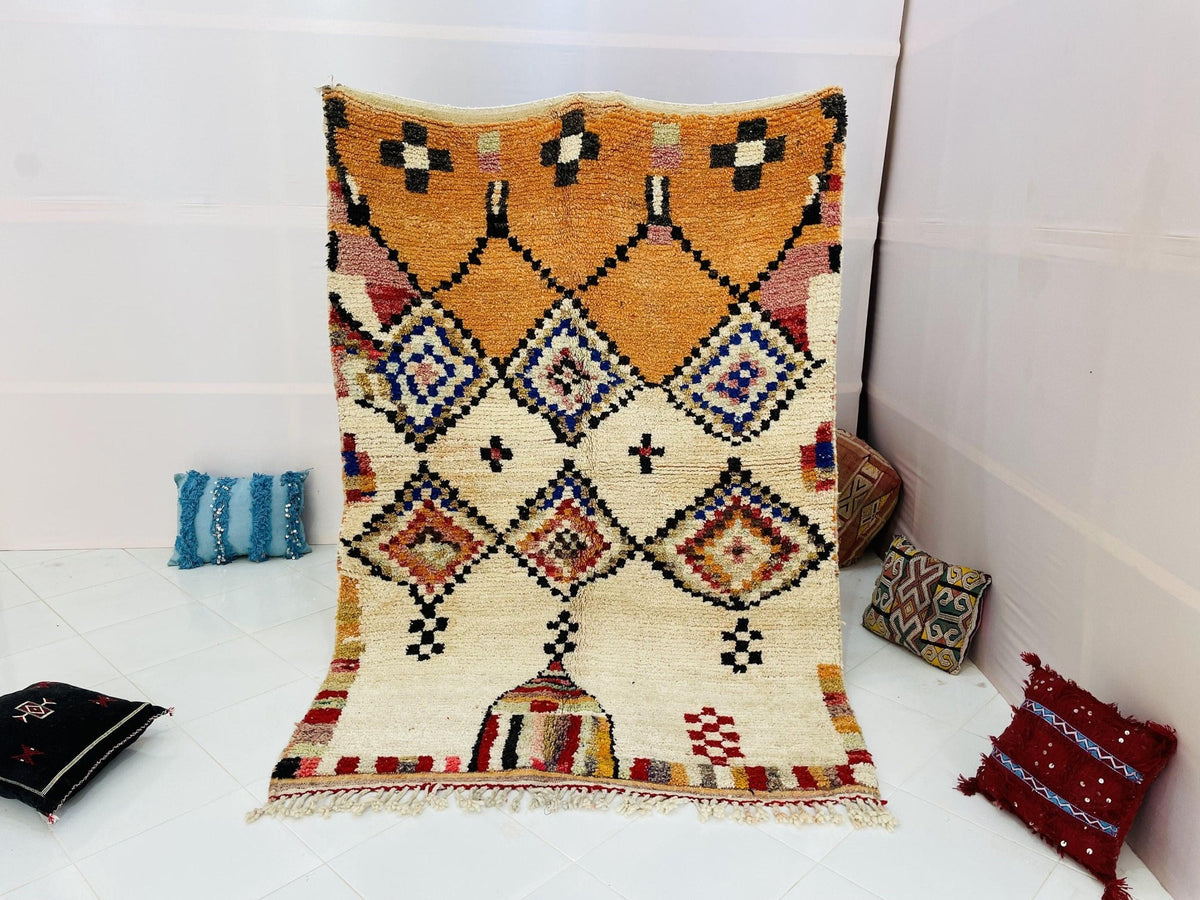 Lifestyle shot of the mustard geometric vintage Moroccan rug on a white background.