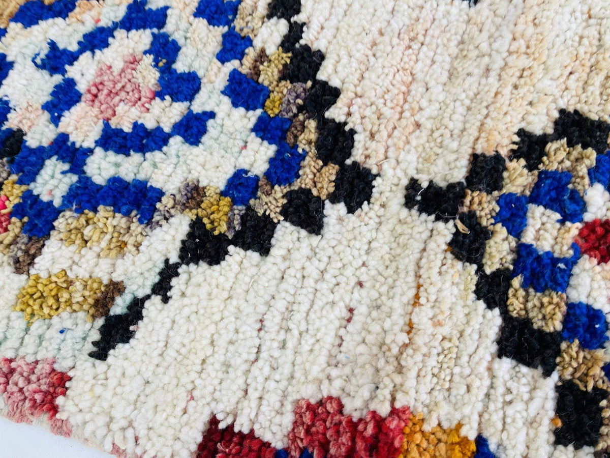 Close-up detail of the geometric design on the vintage Moroccan rug.