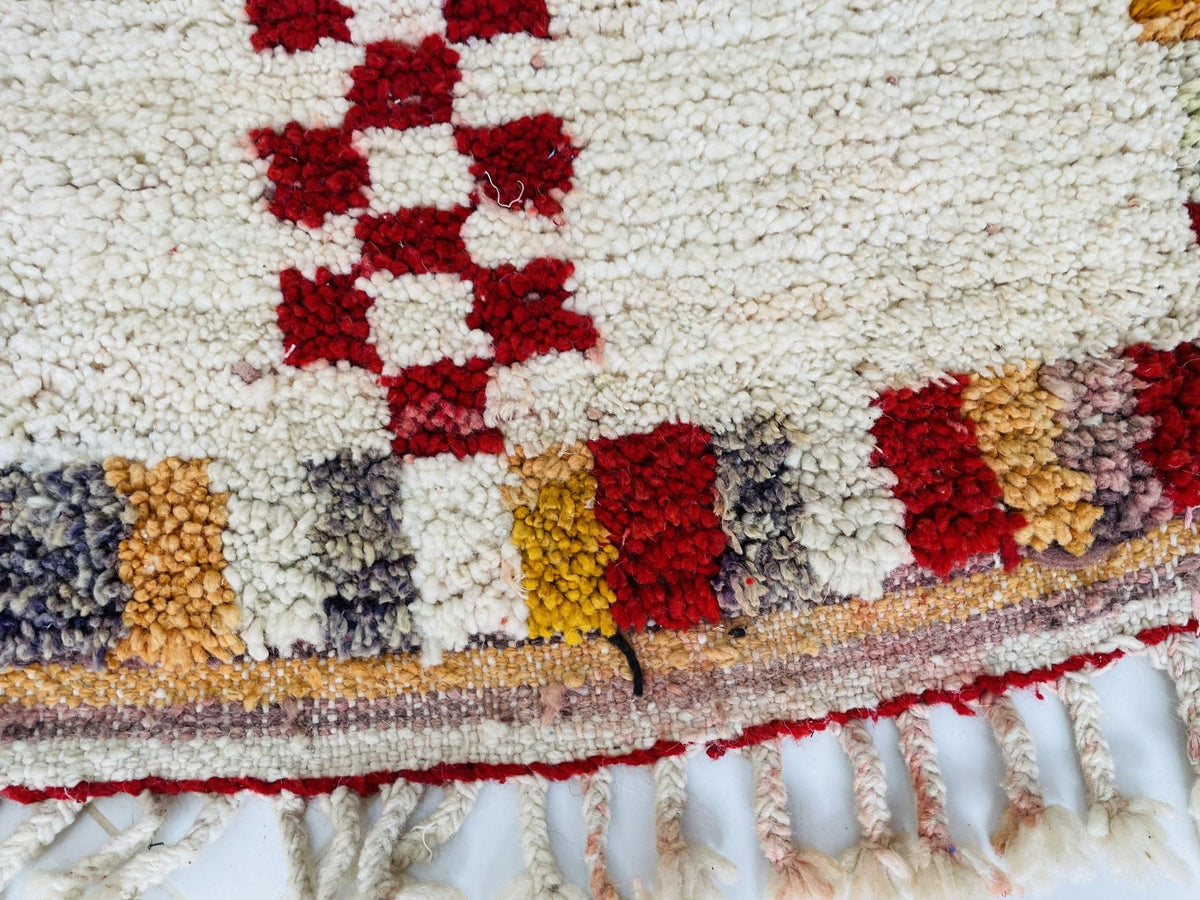 Close-up of the intricate designs and textured surface of the rug pattern.