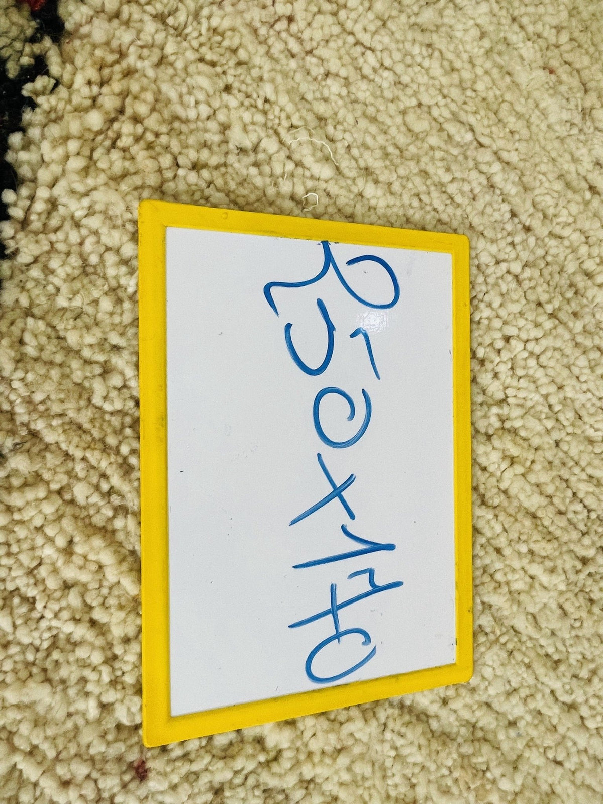 Close-up view of the label with handwritten text on cardboard material.