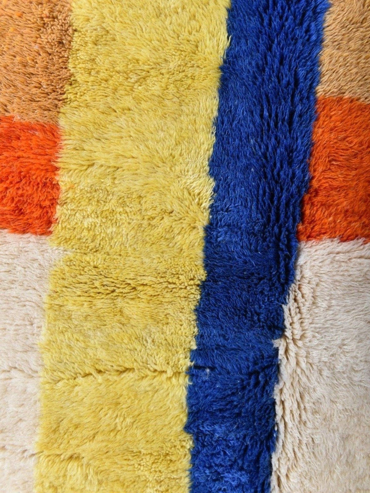Detail close-up of the textured surface of the cream multicolor linear Moroccan rug with colorful stripes.