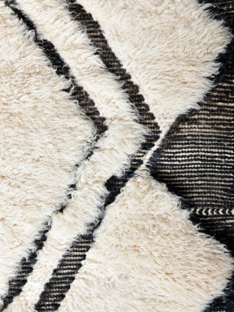 Front view showcasing the cream and black geometric design of the area rug.