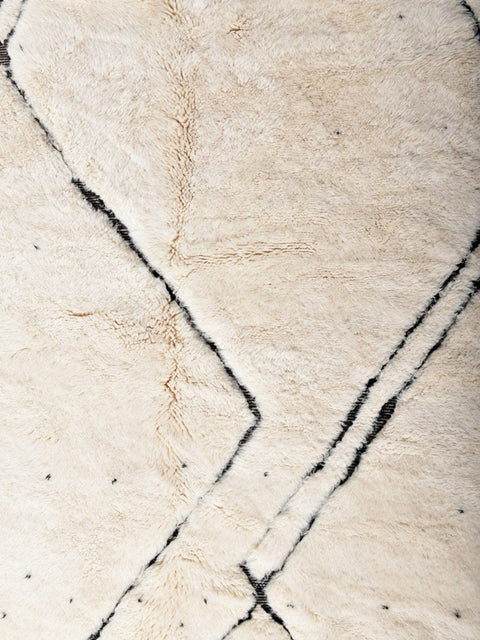 Close-up detail of the geometric area rug featuring an abstract pattern.