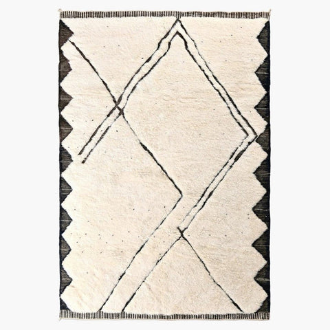 Front view of the cream and black geometric area rug with scalloped edges.