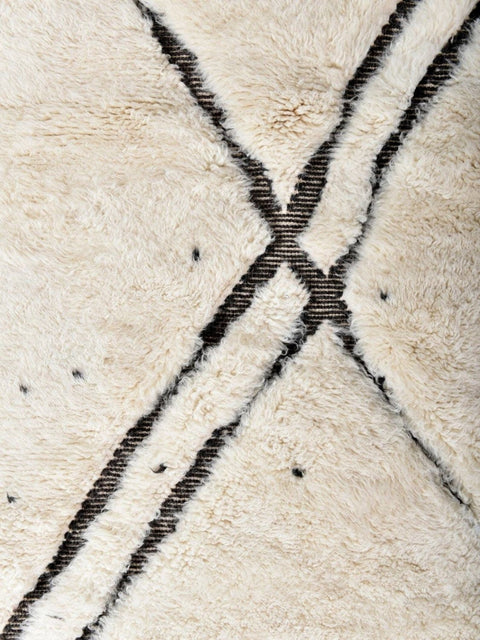 Close-up detail of the textured surface and abstract pattern of the rug.