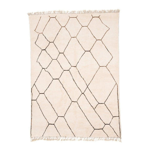 Front view of the geometric black and white area rug with fringe edges.