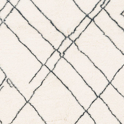 Close-up of the geometric white area rug highlighting its geometric pattern.