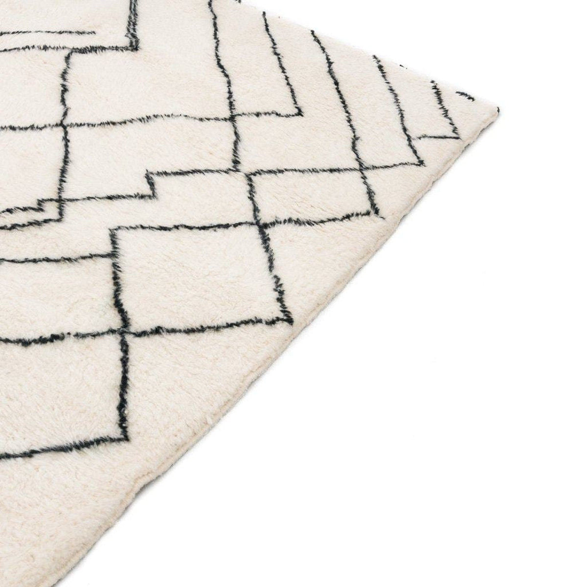 Detail shot of the white area rug showcasing its abstract design.
