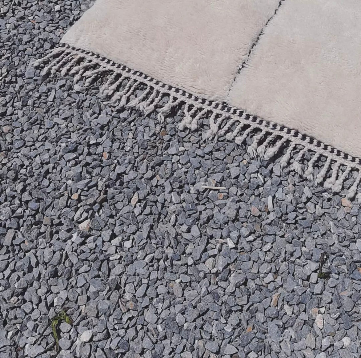 Close-up detail of a white Moroccan Berber rug, emphasizing its unique texture and design.