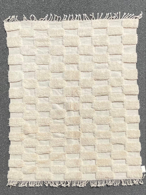 Detail close-up of a white checkered rug showcasing tufted texture.