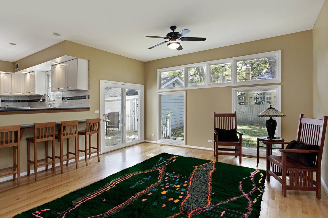 Living room scene with the dark green Berber rug, sofa, and decorative pillows in a minimalist design.