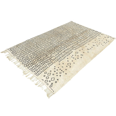 Detail view of the off-white Moroccan rug featuring a modern design.