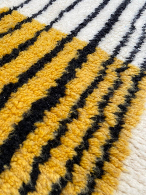 Front view of the yellow and black striped Beni Ourain rug showcasing its design.