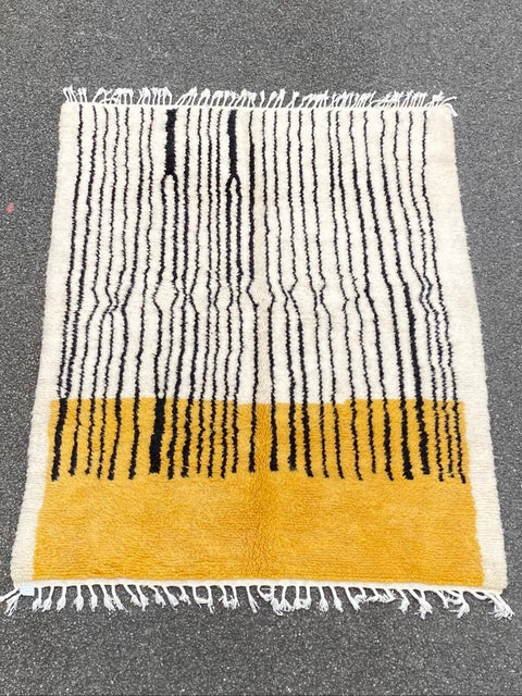 Close-up detail of the textured fibers and striped design of the rug.
