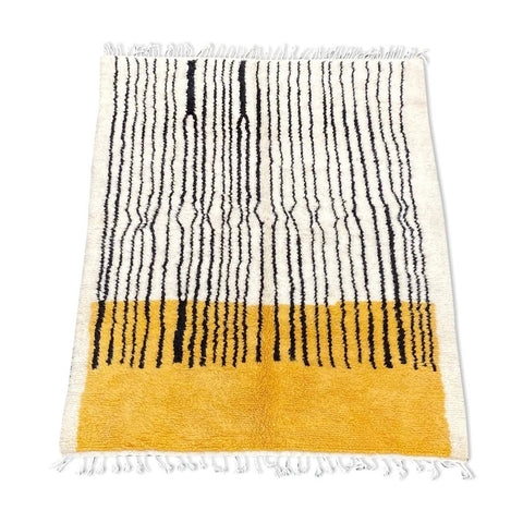 Front view of the yellow and black striped Beni Ourain rug with fringe edges.
